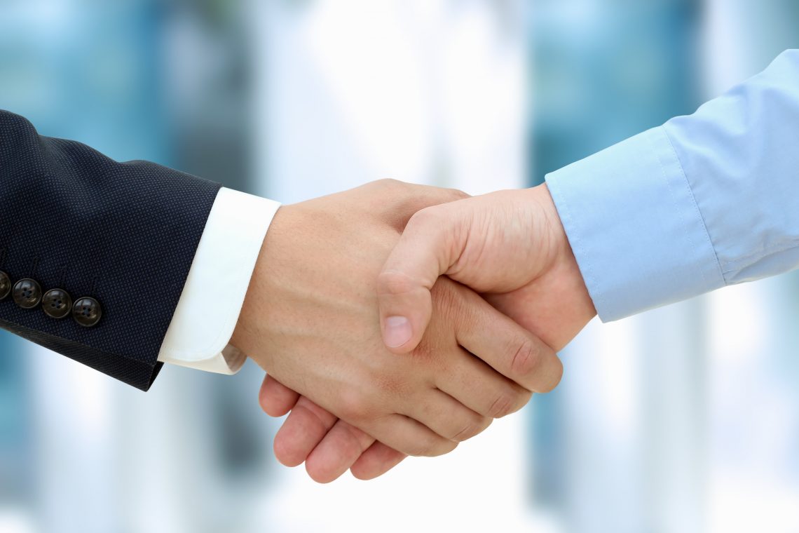 Close-up image of a firm handshake  between two colleagues