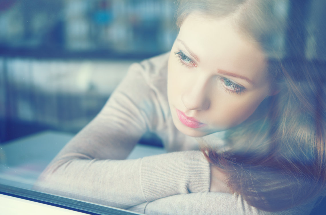 thoughtful sadness girl is sad at window