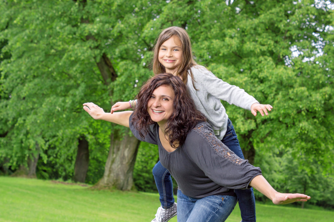 Mother and Daughter dancing in the park